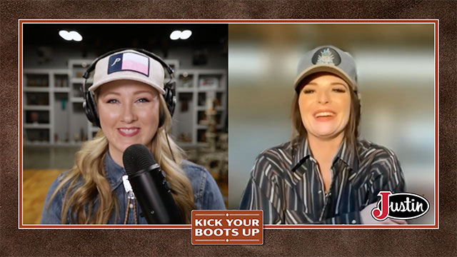 A woman wearing a ball cap talks to a cowgirl country singer-songwriter.